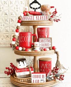 a three tiered christmas tree with coffee cups and mugs on it's sides