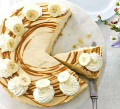 a banana cream pie on a plate with a slice cut out