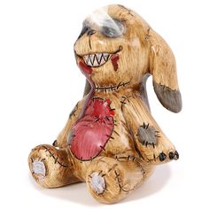 a wooden carved animal with teeth and blood on it's body