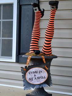 two legs in striped stockings are on top of a spooky potted planter