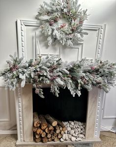 a fireplace with logs and wreaths on top