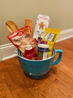 a blue bucket filled with food on top of a wooden floor