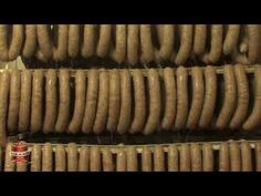 several rows of sausages hanging from the ceiling in a store or restaurant, ready to be cooked