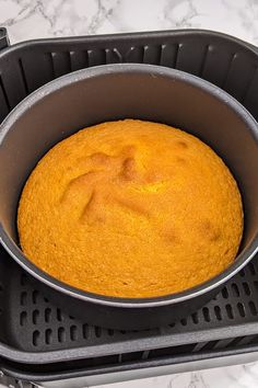 a cake in a pan sitting on top of a stove