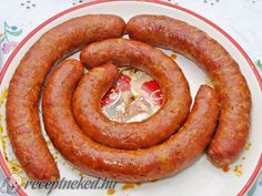 two sausages are on a plate with condiments