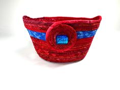 a red and blue basket sitting on top of a white table