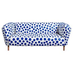 a blue and white couch with polka dots on it