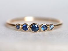 Blue sapphire ring, Blue sapphire stacking ring, dainty ring, stacking ring, stackable ring, blue sapphire ring, Sapphire ringAvailable in 9k/14k/18k yellow, rose or white gold.Same design can be made also with other custom gemstones per request. Product details:- Solid gold- approx 2.5, 2, 1.5 mm sapphire round- Band size is 1.2mmRing size - US 3 to US 9 (for smaller or larger ring size, please contact)Please select your size at the drop down menu. Service Available- Customization Available wit Sapphire Stacking Rings, 3 Stone Sapphire Ring, Adjustable Blue Sapphire Ring, Handmade Adjustable Blue Sapphire Ring, Blue Bezel Set Stackable Rings Fine Jewelry, Blue Fine Jewelry Stackable Rings With Bezel Setting, Blue Stackable Wedding Rings With Bezel Setting, Blue Round Band Jewelry Gift, Blue Stackable Round Band Sapphire Ring