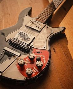 an electric guitar sitting on top of a wooden floor