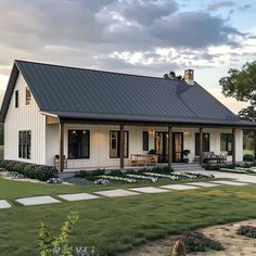 a white house with a black metal roof