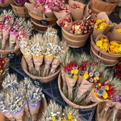 baskets filled with different types of flowers on display