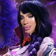 a woman with long black hair and purple makeup