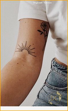 a woman with a tattoo on her arm holding a cell phone in one hand and a flower in the other