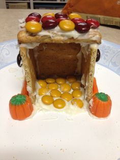 a cake made to look like a house with candy on top