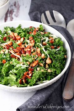 a white bowl filled with lettuce and nuts