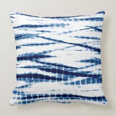 a blue and white tie dyed pillow