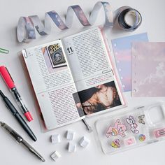 the contents of a planner spread out on a table with scissors, tape and other items