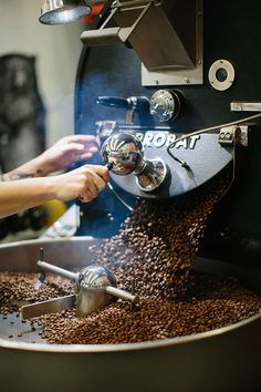 a person pouring coffee into a large pot