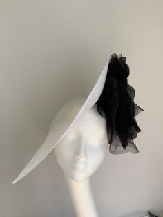 White and black disc hat This amazing white and black hat is made of white sinamay to which I attached black organza and velvet flower. This disc hat will make a statement on any occasion. The hat has a wide headband attached with the comb inside for extra security. White Brimmed Fascinator For Church, White Brimmed Top Hat For Party, White Brimmed Mini Hat For Evening, Chic White Fitted Costume Hats And Headpieces, White Brimmed Hat For Royal Ascot, White Top Hat For Royal Ascot Races, White Brimmed Top Hat For Royal Ascot, White Costume Hat With Short Brim For Races, White Brimmed Mini Hat For Church