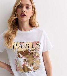 New Look White Cotton Gold Foil Paris Logo T-Shirt. Add a touch of glam to your off-duty look with this white cotton T-shirt, stamped with a gold foil 'Paris' logo. White. 'Paris' gold foil logo. Crew neckline. Short sleeves. Cotton fabric. Model is 5'8"/173cm and wears UK 10/EU 38/US 6. Paris Graphic, Top Jean, Plus Size White, Summer Styling, Paris Logo, Celebrity Names, Denim Gift, 20's Dress, Brunch Outfit