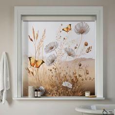 a bathroom window with flowers and butterflies painted on it