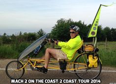 a man riding a bike with a surfboard strapped to it's back and the caption mach 2 on the coast 2 coast tour 2014