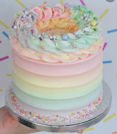 there is a rainbow cake with sprinkles on it