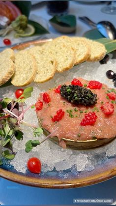 a plate with bread, crackers and berries on it