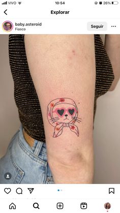 a woman's arm with a cat tattoo on the left side of her arm