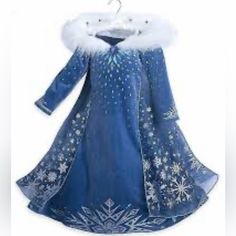 a blue dress with white snowflakes on it and a fur lined hoodie