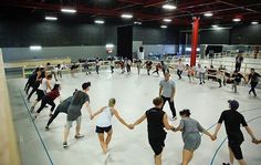 a group of people holding hands in a gym