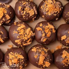 chocolate covered donuts with orange crumbs in a box