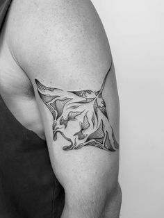 a black and white photo of a man's arm with a horse tattoo on it