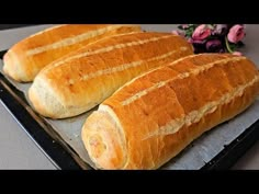 two loaves of bread sitting on top of a pan