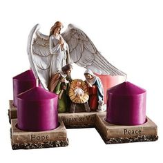 an angel figurine sitting on top of three candles with the words, hope and peace