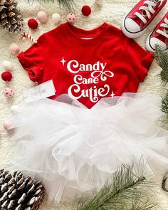 The cutest tee for your little Candy Cane Cutie! This tee is lightweight, very soft cotton and will be perfect for all of your babes favorite holiday festivities! See below for item and shipping details! *About This Tee* -100% cotton  -Extra light fabric (3.9 oz/yd² (132 g/m *About Our Shop* Justy Bae is a brand dedicated to all things GIRL MOM! *Our items ship from multiple warehouses so your order may come in separate shipments* Thanks so much for being here and we hope you LOVE everything!  TURN AROUND TIME  5-7 business days. All items are made and are made to order. Orders may arrive in separate packages  KEEP UP WITH US   Make sure to tag us on instagram @JustyBaeShop for a chance to be featured! Facebook VIP Group: https://www.facebook.com/groups/1012331069371293  Facebook Page: htt Toddler Girl Christmas Outfits, Baby Christmas Shirt, Candy Cane Cutie, Toddler Christmas Shirt, Toddler Christmas Outfit, Holidays With Toddlers, Candy Cane Cookies, Christmas Girls, Toddler Christmas Gifts