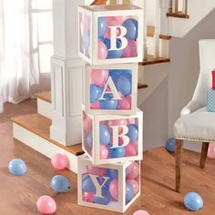 the balloons are all over the floor and around the blocks that spell out the letter b