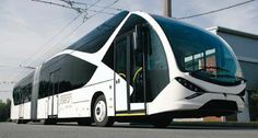 a white bus is parked on the side of the road in front of a building