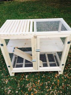 a large wooden cage with two doors open