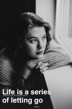 a black and white photo of a woman leaning on a window sill