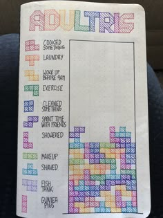 a notepad with some writing on it that has been drawn in different colors and shapes