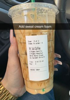 a person holding up a plastic cup filled with liquid