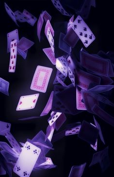 several playing cards are falling into the air