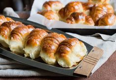 freshly baked croissants are sitting on a tray