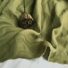 an acorn on a green blanket with white sheets