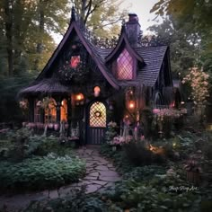 a fairy house is lit up in the evening