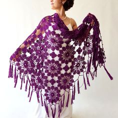 a woman wearing a purple crocheted shawl