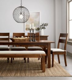 a dining room table with chairs and a bench