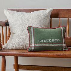 a wooden chair with two pillows on it and a pillow that says, joyett'n noel