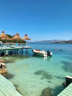 boats are docked in the clear blue water